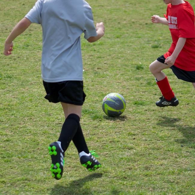 two people playing soccer on grass field 650-0axqBrI8Or4-unsplash james-lee_.jpg